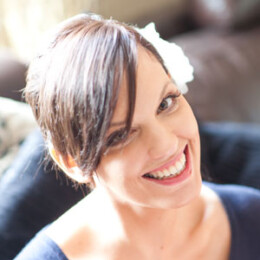 A simple updo fixed with a delicate white floral clip, to match the colour theme of the day. Bridal image
