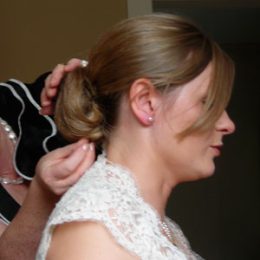 This is an example of our Bridal hair, a simple up-do fixed with a delicate white floral clip, to match the colour theme of the day. Bridal image